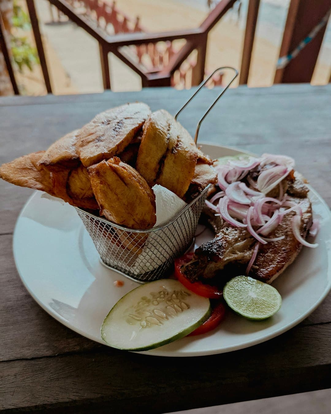 Fried plantain with grilled fish and onions
